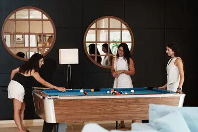 a kitchen with a bar with stools in it at Hotel Ignacio - PalomarGroup in Chiva