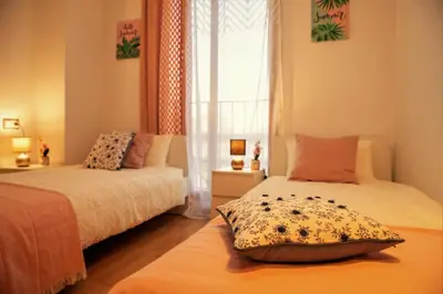 a bedroom with two beds and a window at Penthouse Duplex in a 4 floors spanish house -8 min to center by Metro in Valencia