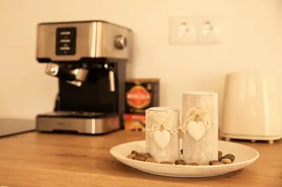 two candles on a plate on a counter with a coffee maker at Penthouse Duplex in a 4 floors spanish house -8 min to center by Metro in Valencia