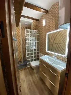 a bathroom with a toilet and a sink and a mirror at La Carchata in Siete Aguas