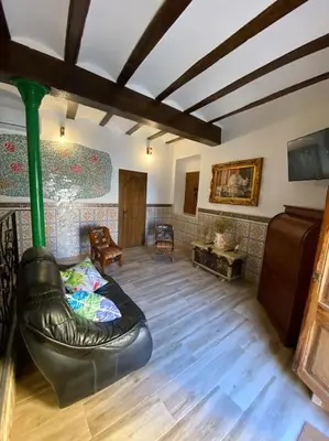 a living room with a couch in the middle of a room at La Carchata in Siete Aguas