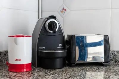 a coffee maker sitting on a counter next to a toaster at ApartUP Patacona Orchard Views in Valencia