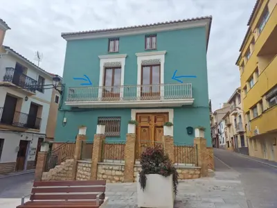 a blue house with graffiti on it on a street at La carchata 1 in Siete Aguas