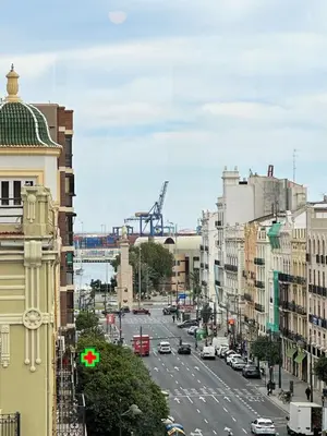 a busy city street with a crane in the background at Your Sunny & Spacious Portview Home in Valencia