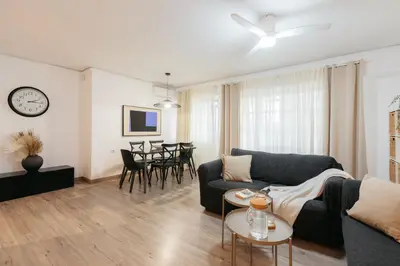 a living room with a couch and a table at Your Sunny & Spacious Portview Home in Valencia