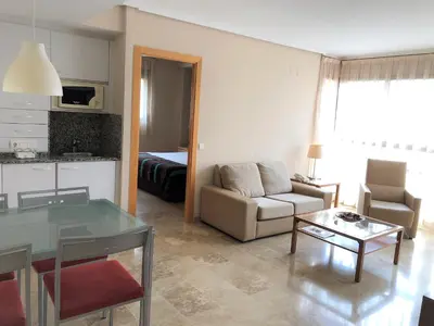 a living room with a couch and a table at Apartamentos Plaza Picasso in Valencia