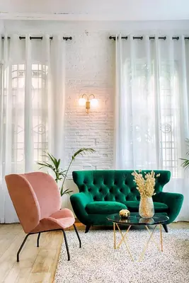 a living room with a green couch and a chair at Blanq Carmen Hotel in Valencia