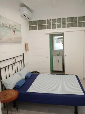 a bathroom with a toilet and a shower and a sink at Rooms Burjassot in Burjasot
