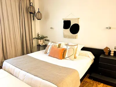 a bedroom with a large white bed with pillows at AZZ Valencia Táctica Hotel in Paterna