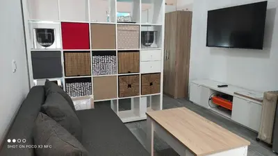a living room with a couch and a tv at APARTMENTSUITESPAIN PLAYA - UNIVERSIDADes in Valencia
