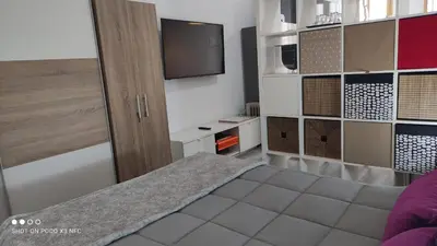 a bedroom with a bed and a tv on a wall at APARTMENTSUITESPAIN PLAYA - UNIVERSIDADes in Valencia