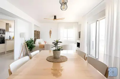 a dining room with a table and chairs at El Acuario - Primera línea y todas las ventanas dan al mar in Cullera