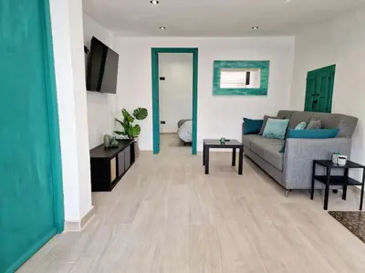 a living room with a couch and a table at APARTAMENTO CON TERRAZA Y BARBACOA in Paterna