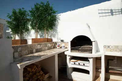 a kitchen with a counter with a pizza oven at APARTAMENTO CON TERRAZA Y BARBACOA in Paterna