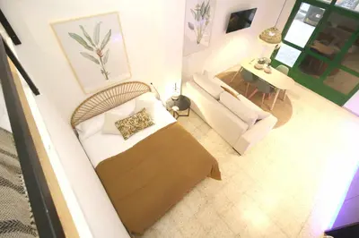 an overhead view of a bedroom with a bed and a couch at Apartamento Menorca Apartamento n1 in Valencia