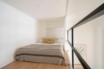 a bedroom with a bed in a white room at Apartamento Menorca Apartamento n1 in Valencia