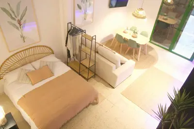 a bedroom with a bed and a couch and a table at Loft Ibiza Apartamento n2 in Valencia