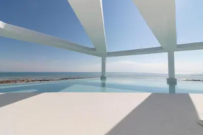 a swimming pool with a view of the ocean at Global Vacacional, Apartamento con terraza y vistas a la piscina en Gran Canet in Canet de Berenguer