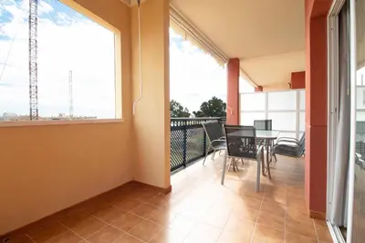 an empty balcony with a table and chairs on it at Global Vacacional, Apartamento con terraza y piscina en la playa de Canet in Canet de Berenguer