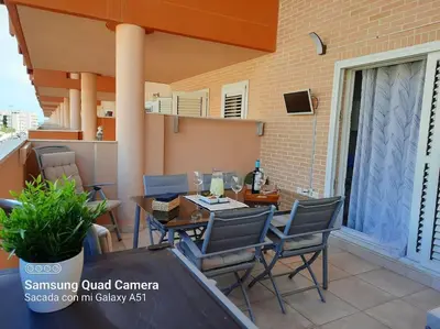 a patio with a table and chairs on a balcony at Exclusivo apartamento en Canet in Canet de Berenguer