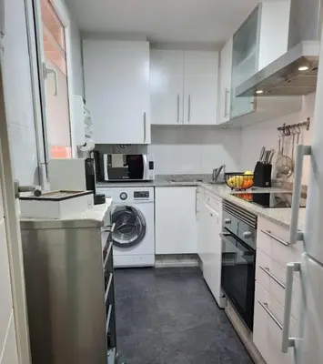 a kitchen with white cabinets and a dishwasher at Exclusivo apartamento en Canet in Canet de Berenguer