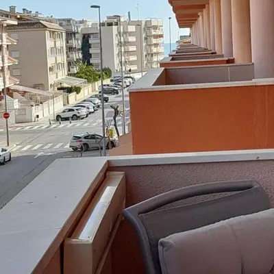 a chair sitting on top of a building with a street at Exclusivo apartamento en Canet in Canet de Berenguer