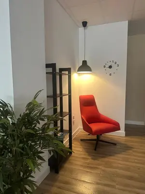 a red chair in a room with a plant at Apartamento tipo loft valencia in Paiporta