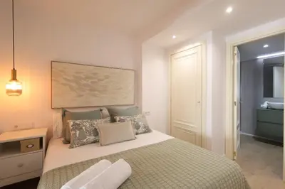 a bedroom with a large bed with pillows at FLORIT FLATS - The Apolo Apartment in Valencia