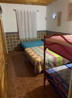 a bedroom with two bunk beds and a window at El-cortijo in Siete Aguas