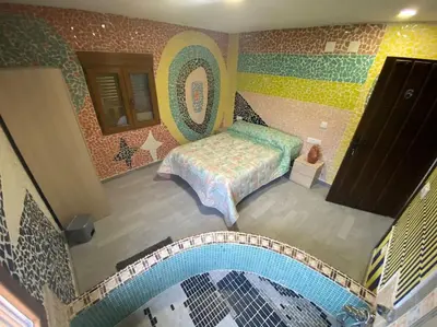 an aerial view of a bedroom with a bed and a pool at LA CASONA in Siete Aguas