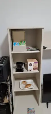 a bathroom with a toilet and a light on the wall at Habitación familiar Portalet in Benaguacil