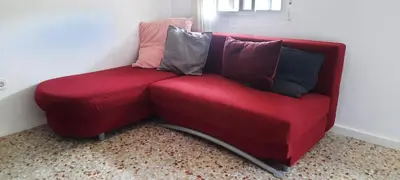 a red couch with pillows on it in a room at Casa Mas Montañas in Godelleta