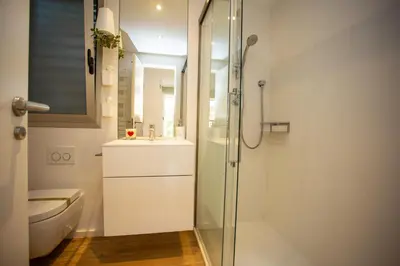 a bathroom with a shower and a sink and a toilet at Cullera Beach Apartment Cap Blanc in Cullera