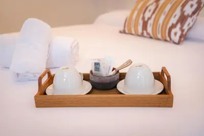 a wooden tray with two cups and plates on a bed at Casa Bassa Hotel in Valencia
