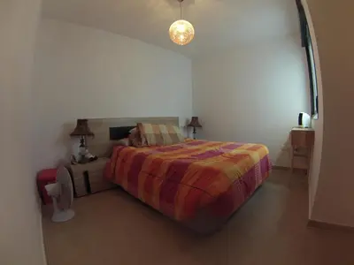 a bedroom with a bed with a colorful bedspread at FeWo - Moncofa Apartment in Moncófar