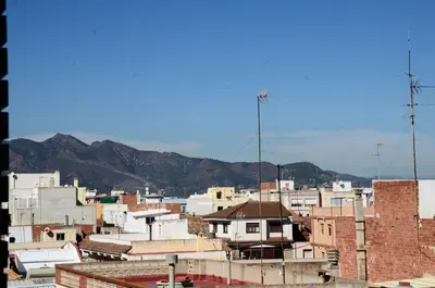 a group of buildings with mountains in the background at FeWo - Moncofa Apartment in Moncófar