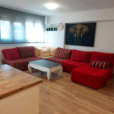 a living room with a red couch and a table at Family Apartment Andrea in Alaquas