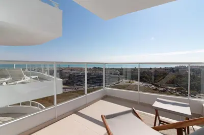 an apartment with a balcony with a view of the ocean at Moderno apartamento con vistas a la costa mediterranea en Gran Canet in Canet de Berenguer