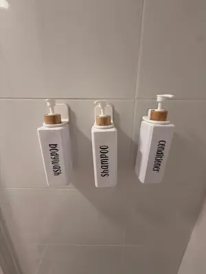 a group of three white bottles on a wall at Habitaciones con cocina y baño privado de temporada Vacaciones largas Long Stay desde 11 noches in Valencia
