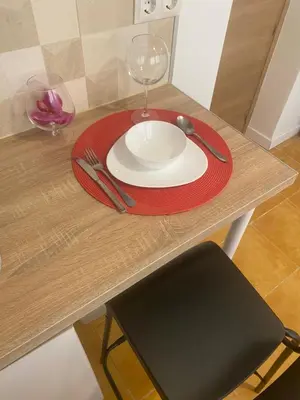 a table with a plate and a wine glass on it at Habitaciones con cocina y baño privado de temporada Vacaciones largas Long Stay desde 11 noches in Valencia