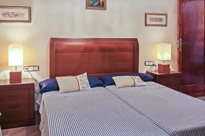 a bedroom with a large bed with blue and white sheets at Huerto Valenciano - Sol y Tranquilidad - Piscina in Valencia