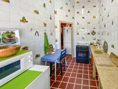 a kitchen with a sink and a stove in it at Huerto Valenciano - Sol y Tranquilidad - Piscina in Valencia