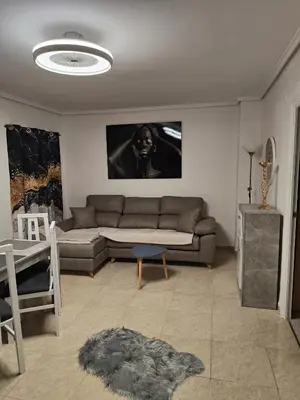 a living room with a couch and a table at Estrella playa in Puerto de Sagunto