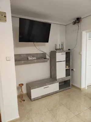 a living room with a flat screen tv on the wall at Estrella playa in Puerto de Sagunto