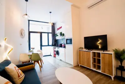 a living room with a couch and a tv at B2 Verdeguer - Cozy Loft close to the beach in Valencia