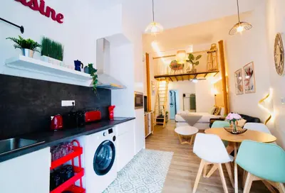 a kitchen and living room with a table and chairs at B2 Verdeguer - Cozy Loft close to the beach in Valencia