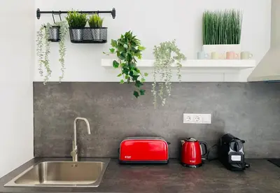 a kitchen counter with a red toaster and a sink at B3 Verdeguer - Cozy Loft Close to the Beach in Valencia