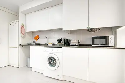 a kitchen with white cabinets and a washing machine at Sagunto - Albalat de Tarongers - Estivella - Gilet in Albalat de Taronchers