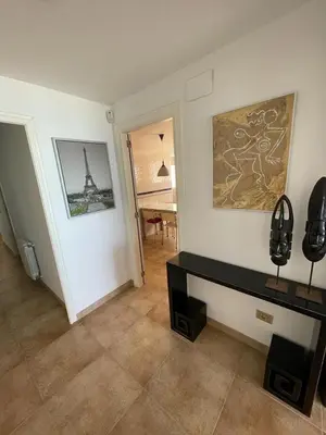 a living room with a table and a picture on the wall at FRENTE AL MAR in Burriana