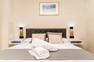 a bedroom with two beds with white sheets and pillows at El Labrador in Anna